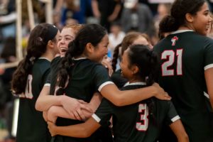 Santa Fe Christian's womens volleyball team celebrate winning CIF division championship game with a spitired huddle.